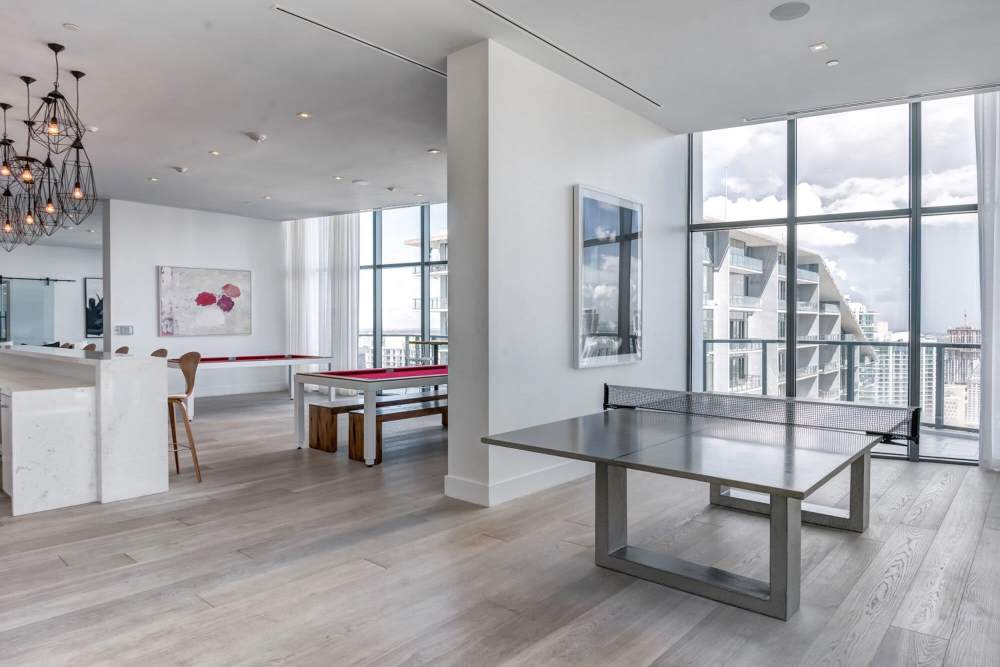 Resident clubhouse with a ping-pong table at Solitair Brickell Apartments in Miami, Florida