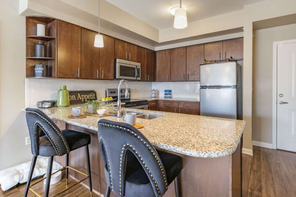 kitchen with stainless-steel appliances at ((location_name}} in Kansas City, MO