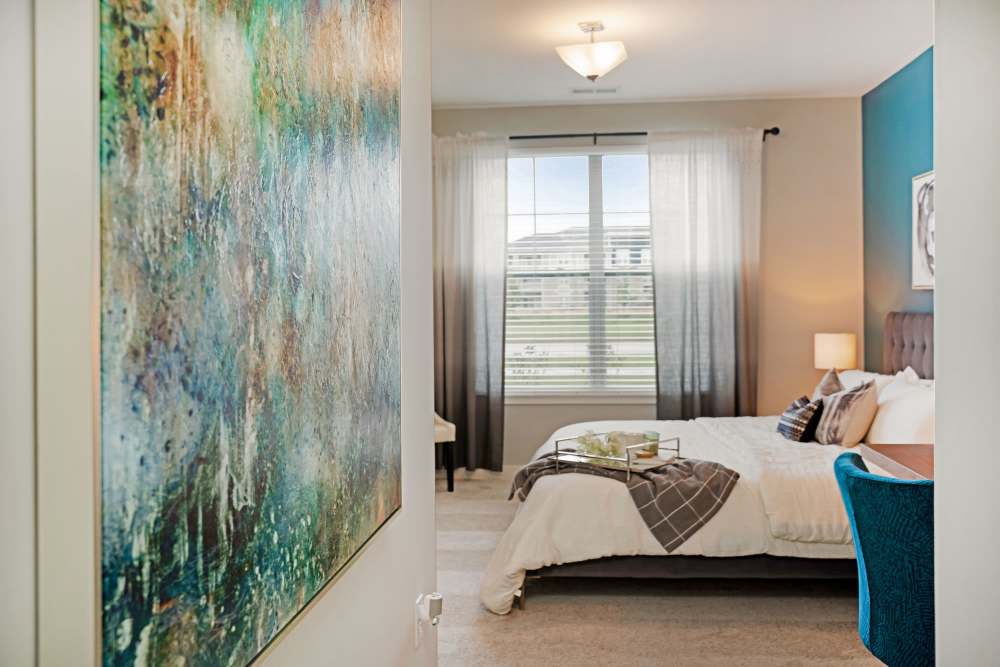 bedroom with art on the wall at ((location_name}} in Avon, IN