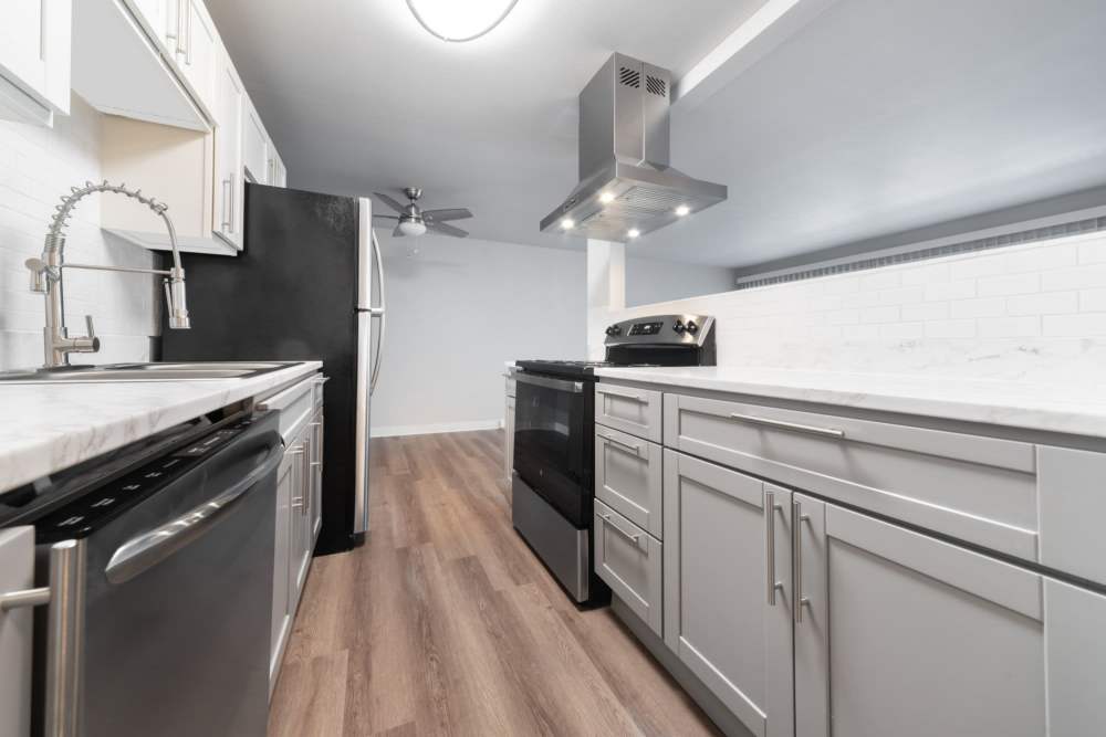 Kitchen with multiple wooden cabinets and granite countertops at Lantera Apartments in Seattle, Washington