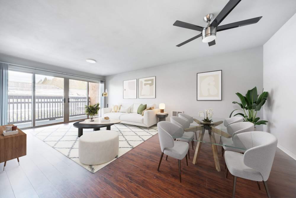 Spacious living room with a couch, large sliding door and a ceiling fan at Lantera Apartments in Seattle, Washington