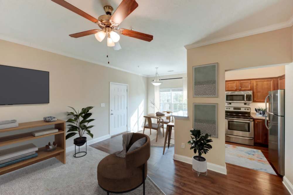 Living room with ceiling fan at Sage Creek Apartments in Augusta, Georgia