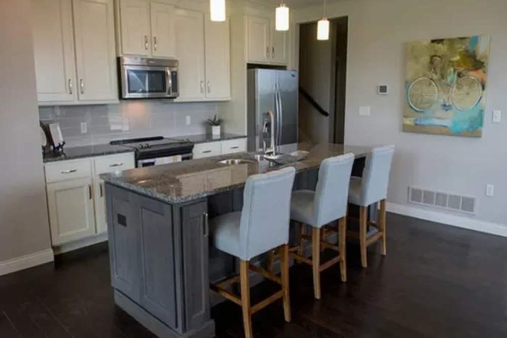 Apartment kitchen with white cabinets at The Residences at Old Hawthorne in Columbia, Missouri