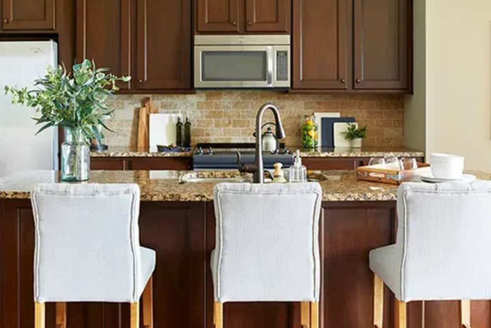 Kitchen with granite counters and counter seating at The Residences at Old Hawthorne in Columbia, Missouri