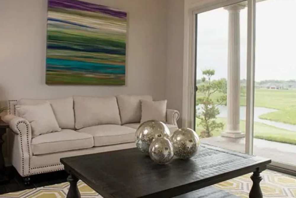 Living room with sliding glass door at The Residences at Old Hawthorne in Columbia, Missouri