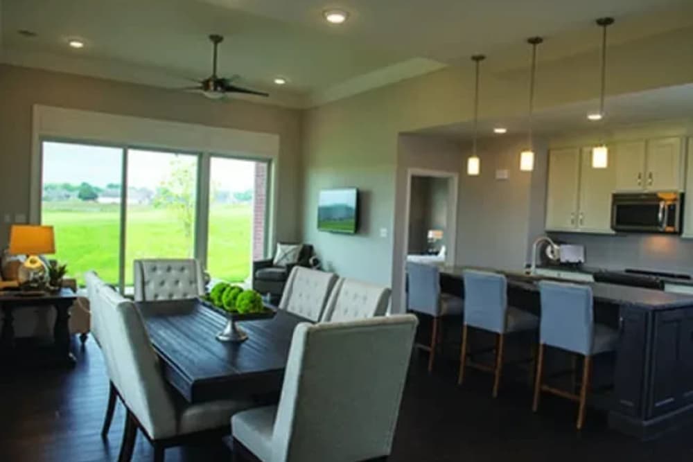 Dining area near the kitchen with hardwood flooring at The Residences at Old Hawthorne in Columbia, Missouri