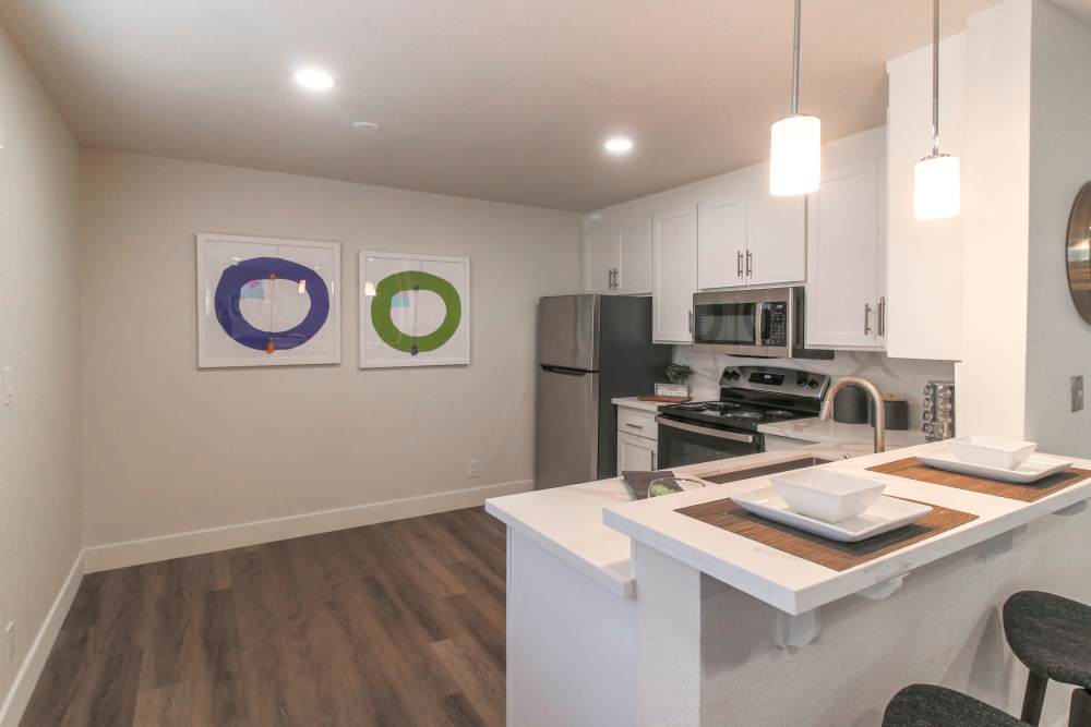 A modern kitchen featuring a stylish bar area and a sleek refrigerator, creating a functional and inviting space at Davis, California