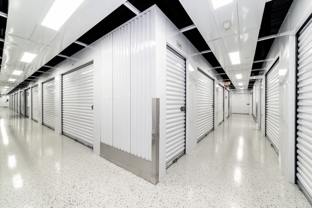 Well-lit hallways between storage units at Your Storage Units Ft. Myers in Fort Myers, Florida