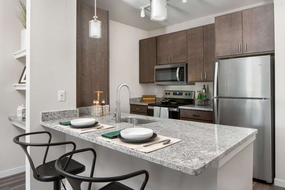 Kitchen with stainless-steel appliances at ((location_name}} in Brown Deer, WI