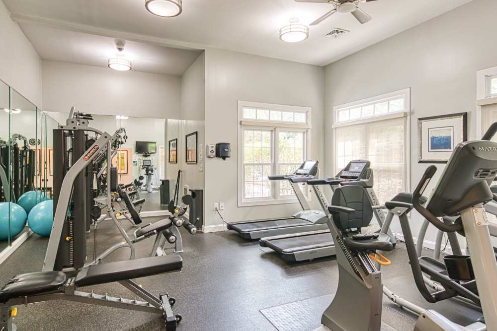 Well-equipped fitness center with large windows, ceiling fans at Beacon Place at Kentlands in Gaithersburg, Maryland  