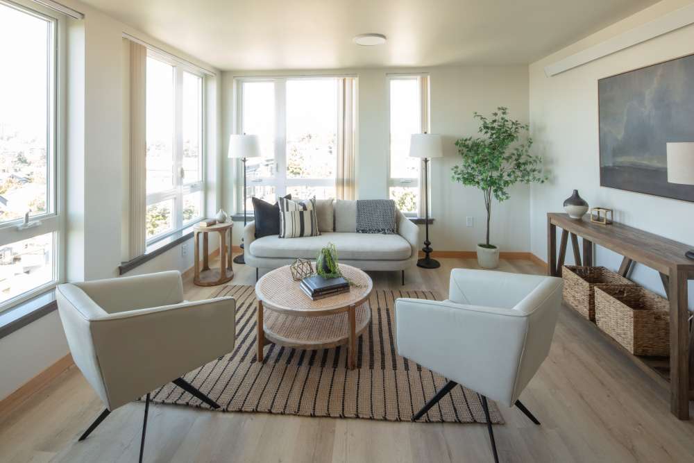 Living room with city view and round coffee table at Bryant Manor in Seattle, Washington
