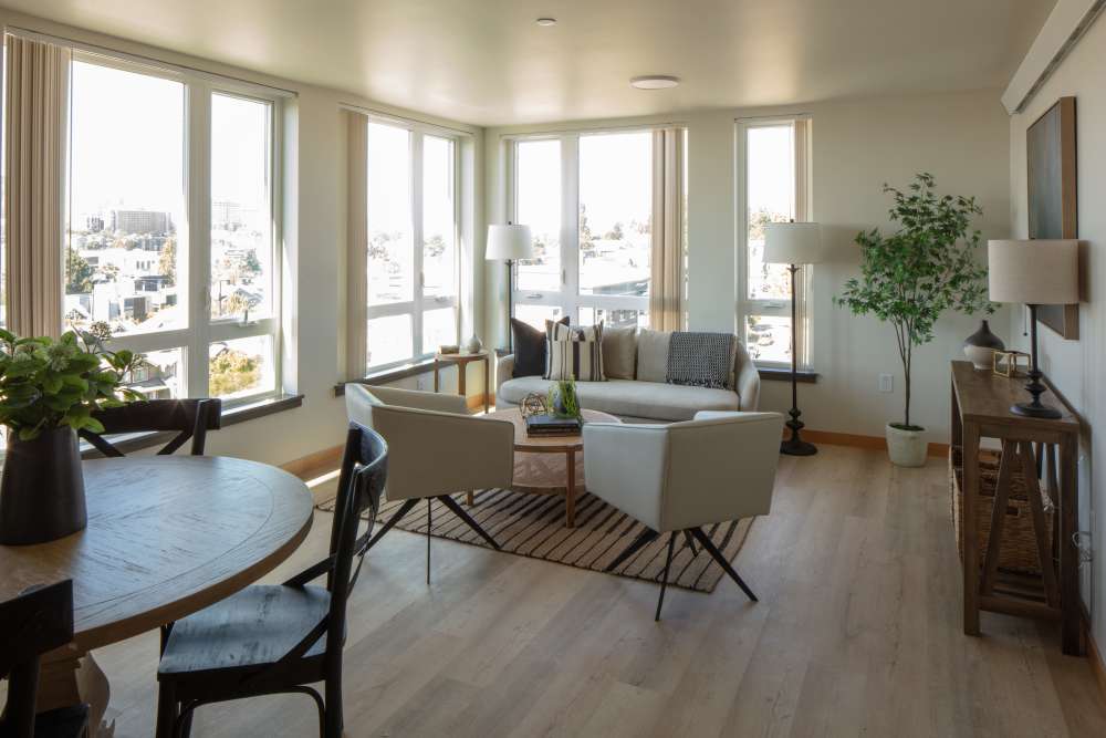 Spacious and beautiful living room with couches and big windows at Bryant Manor in Seattle, Washington