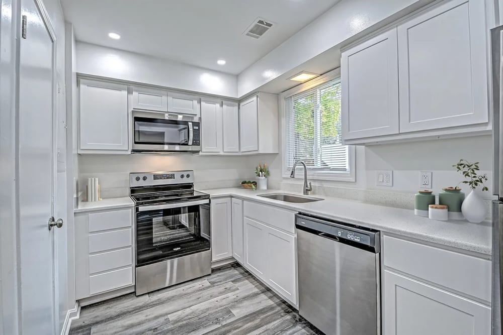 Modern kitchen with granite countertops, stainless-steel appliances and a dishwasher at Woodside Village in Valparaiso, Indiana