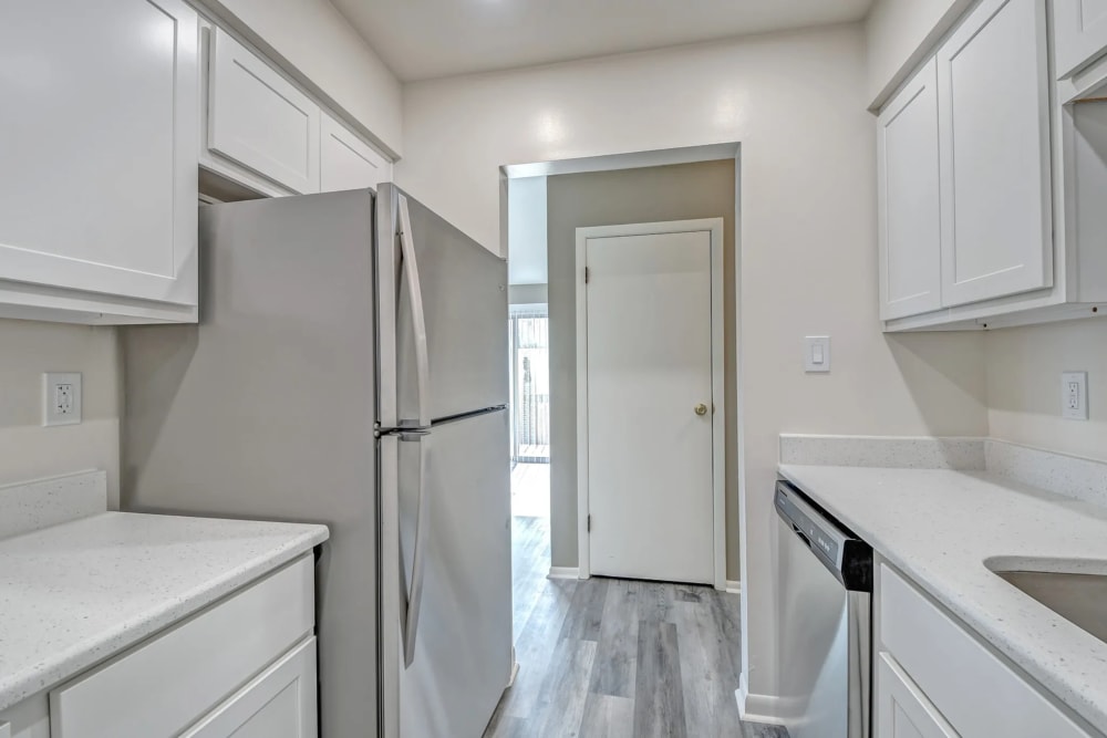 Bright kitchen with a refrigerator, stainless-steel appliances at Woodside Village in Valparaiso, Indiana
