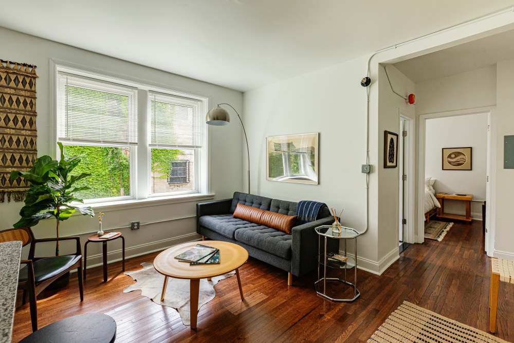 Open layout living room with hard-wood style flooring at Detroit Living in Detroit, Michigan