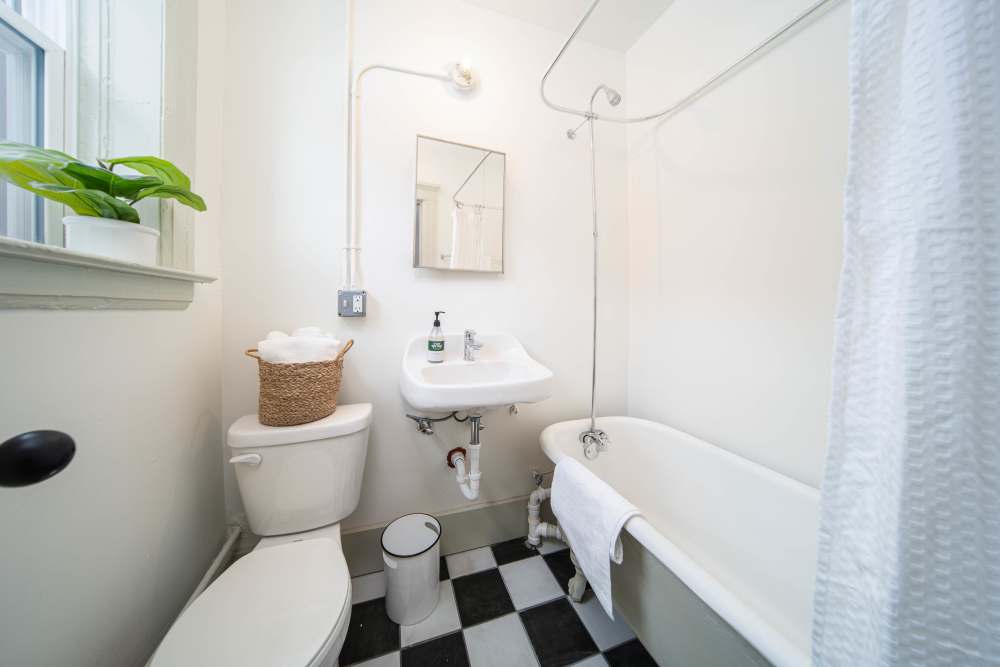 Bathroom with hard flooring, waterfall faucet sink at Detroit Living in Detroit, Michigan