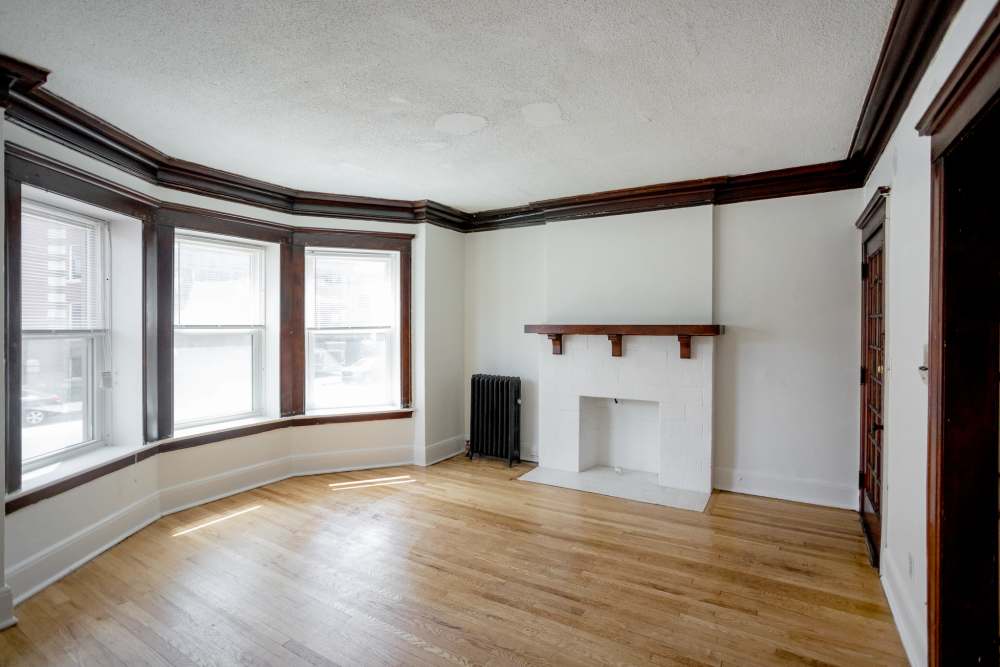 Spacious living room with wood-style flooring at Detroit Living in Detroit, Michigan