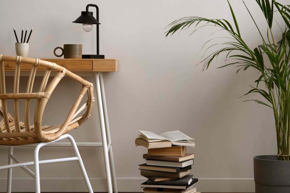 Wooden chair with books and plant to the side at Reeds Landing Apartments in Edmond, Oklahoma