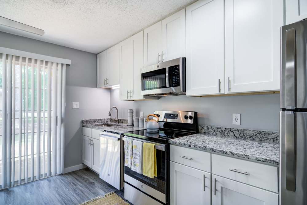 Hardwood-style flooring in modern kitchen at Kenridge Apartments in Decatur, Georgia