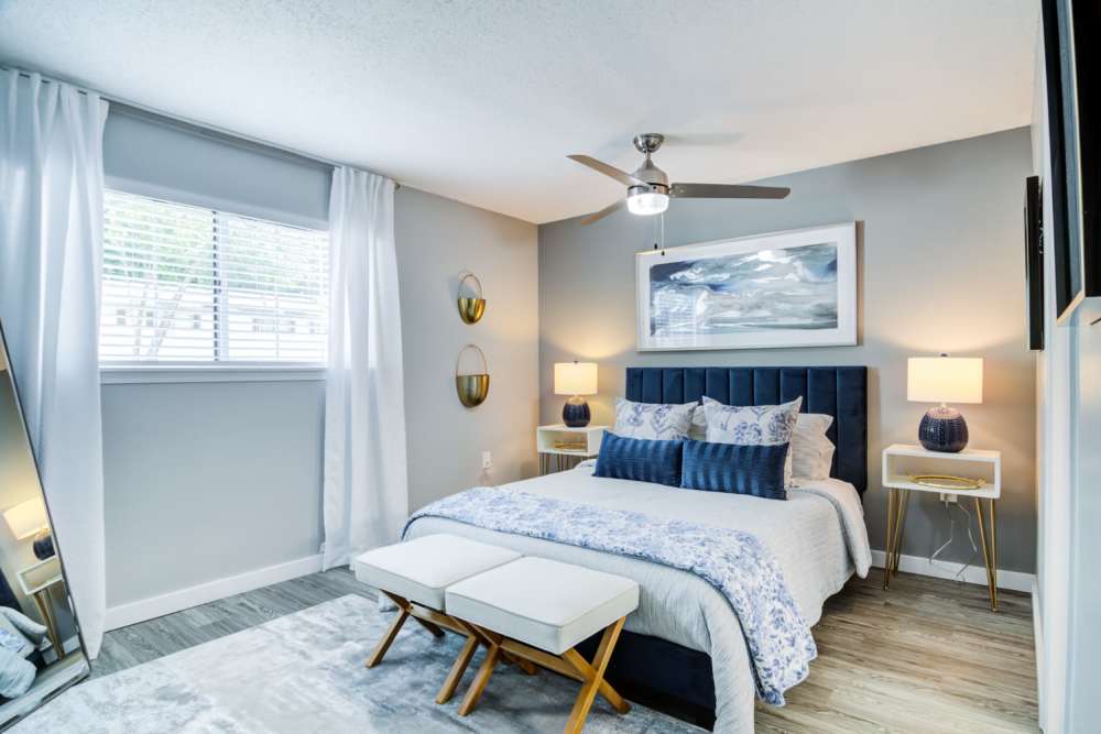 Bedroom with large window and ceiling fan at Kenridge Apartments in Decatur, Georgia