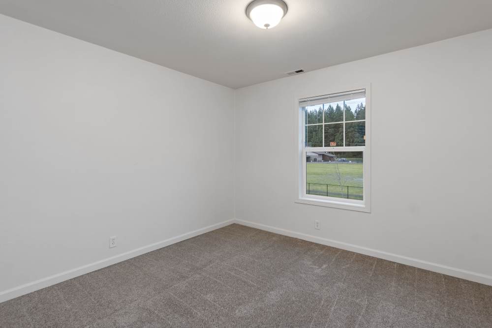 Large Bedroom with Plush Carpeting in Discovery Village
