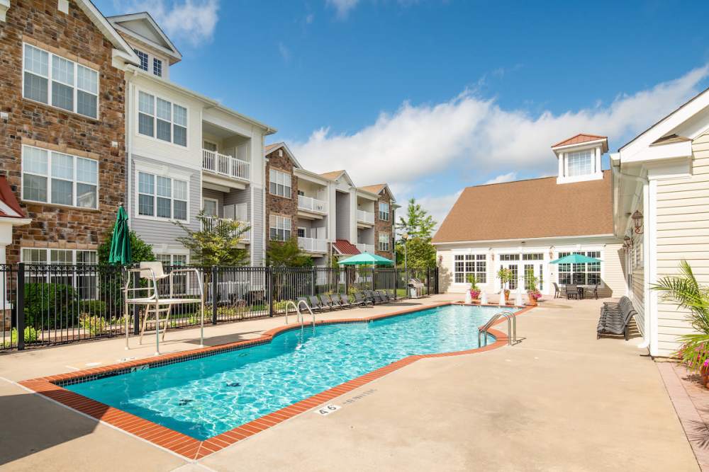 Resort-style large swimming pool with lounge chair at The Elms at Montjoy in Ellicott City, Maryland
