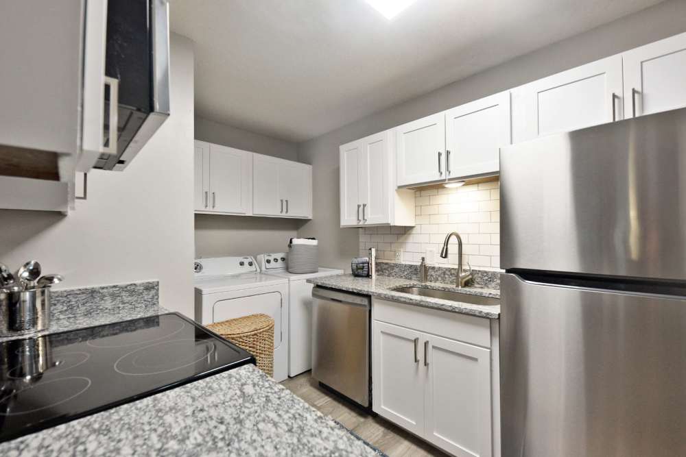 Apartment kitchen with white cabinetry and trendy appliances at Arcadia Creekside in Chattanooga,Tennessee