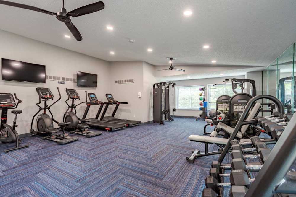 Fully-equipped gym with treadmills, weight machines at Pavilion Court Apartment Homes in Novi, Michigan