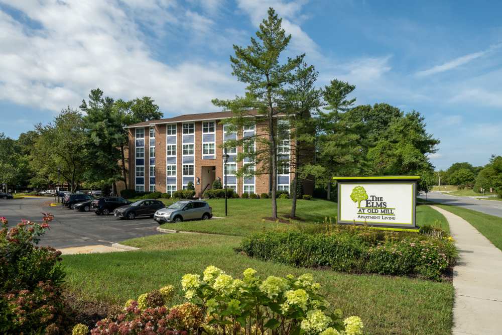 Community exterior with signage at The Elms at Old Mill in Millersville, Maryland  