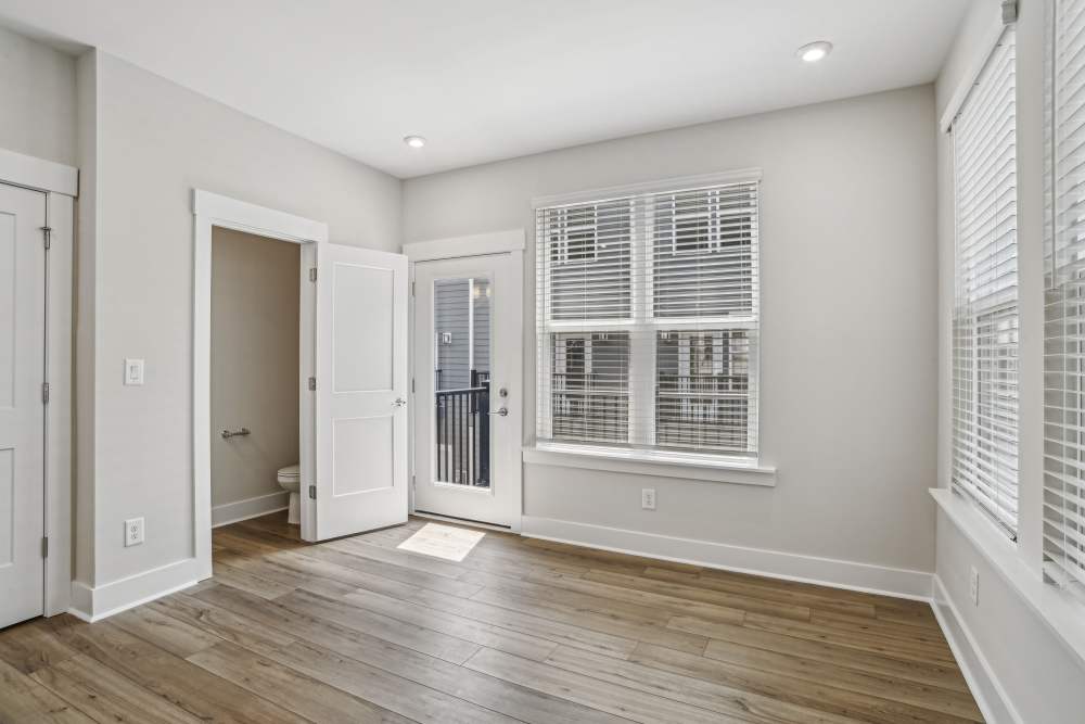 Unfurnished living room with an entrance door and white accent throughout at Reve Noda Junction in Charlotte,North Carolina