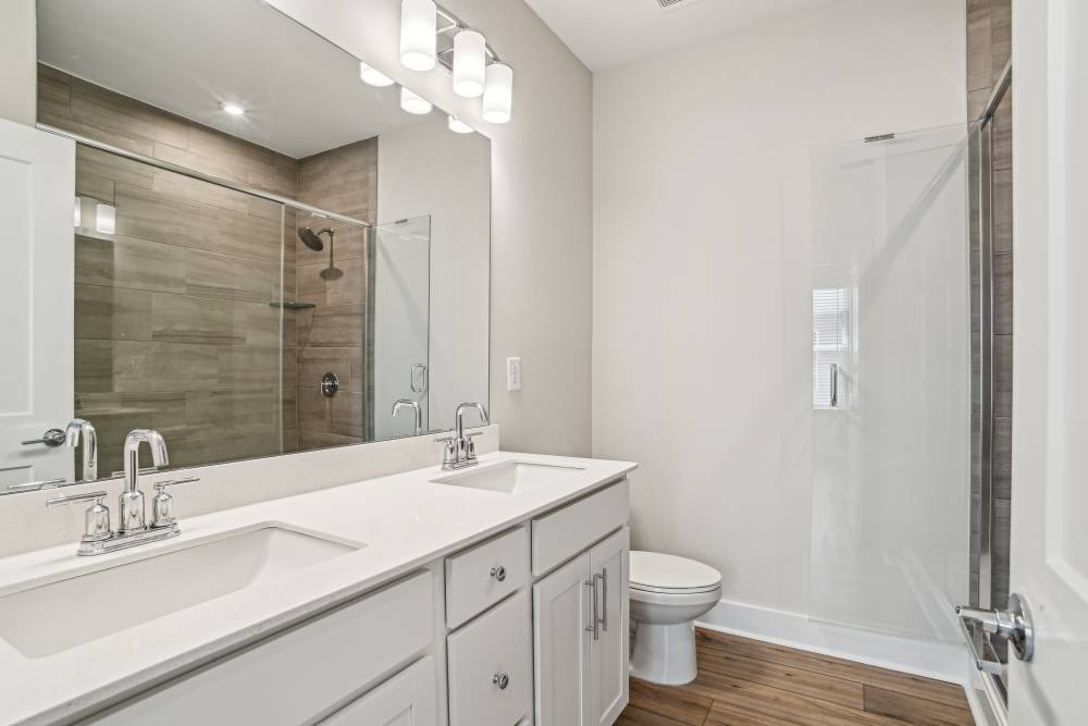 Bright bathroom with a white vanity unit and large mirror at Reve Noda Junction in Charlotte,North Carolina