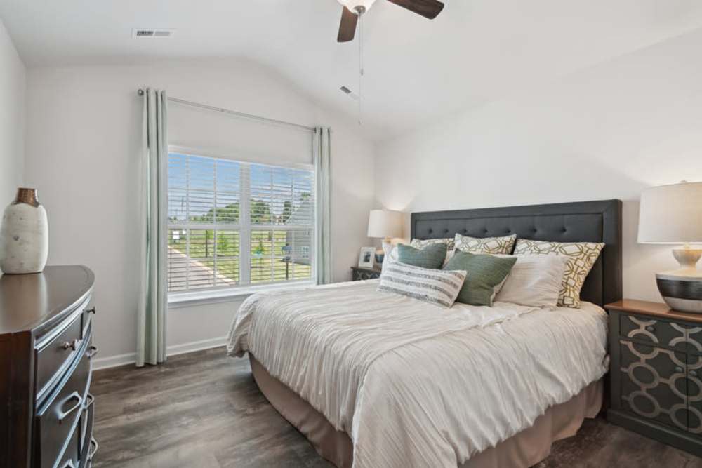 Apartment bedroom with comfortable bed at Norman Ridge Townhomes in Terrell, North Carolina