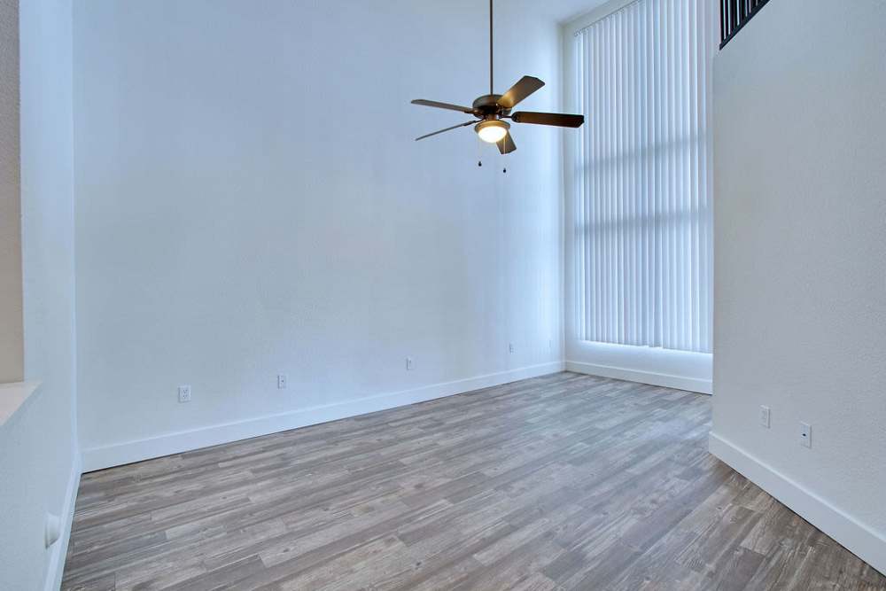Living room with wood-style floors and ceiling fan at Ninety Degrees in Phoenix, Arizona