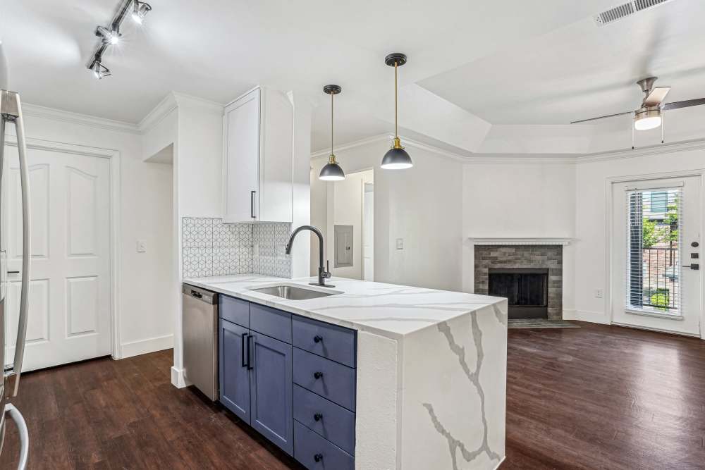 Kitchen with cabinets and hanging lights at Cypress in McKinney, Texas