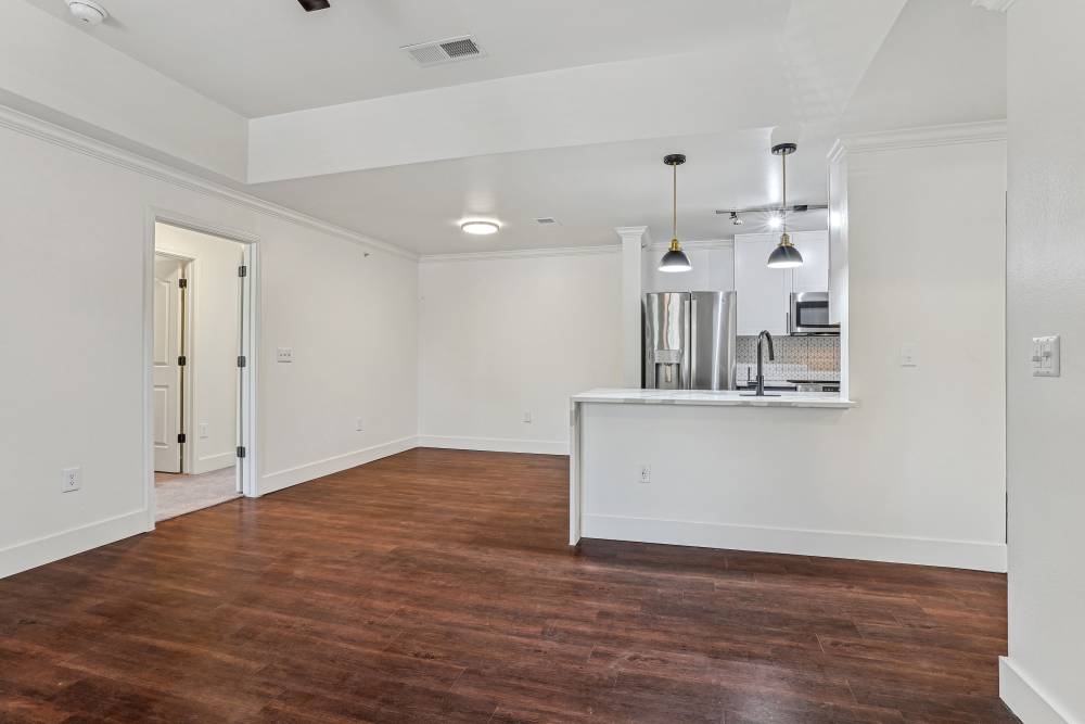 Living room with a view of kitchen at Cypress in McKinney, Texas