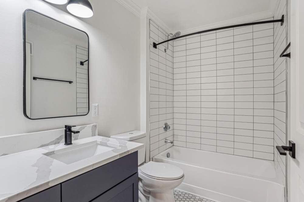 Bathroom with tiled shower at Cypress in McKinney, Texas