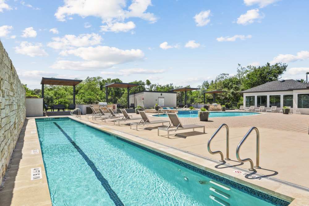 Angle view of the pool with relaxing chairs at Milan in Austin, Texas
