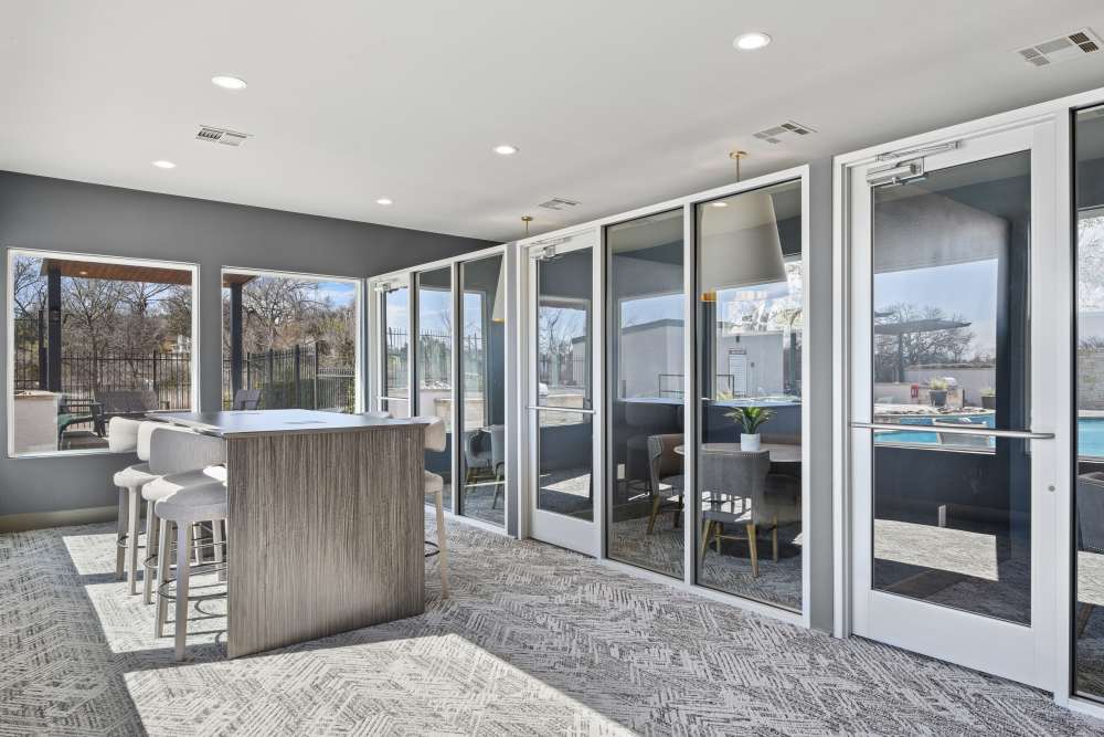 View of the community lunge with island and chairs at Milan in Austin, Texas
