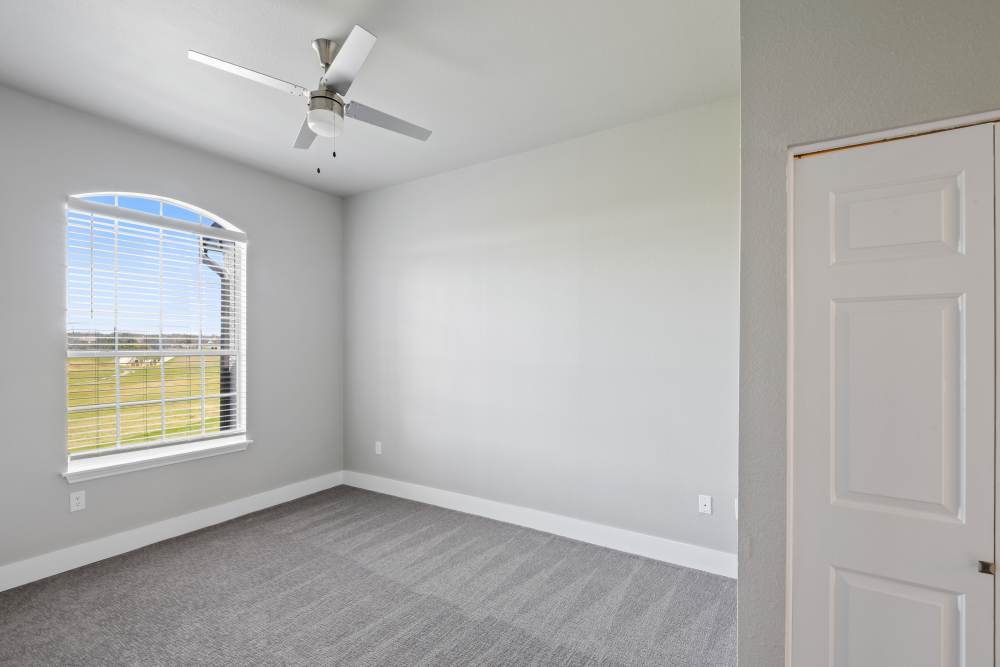 Room with hardwood flooring with ceiling fan at Milan in Austin, Texas