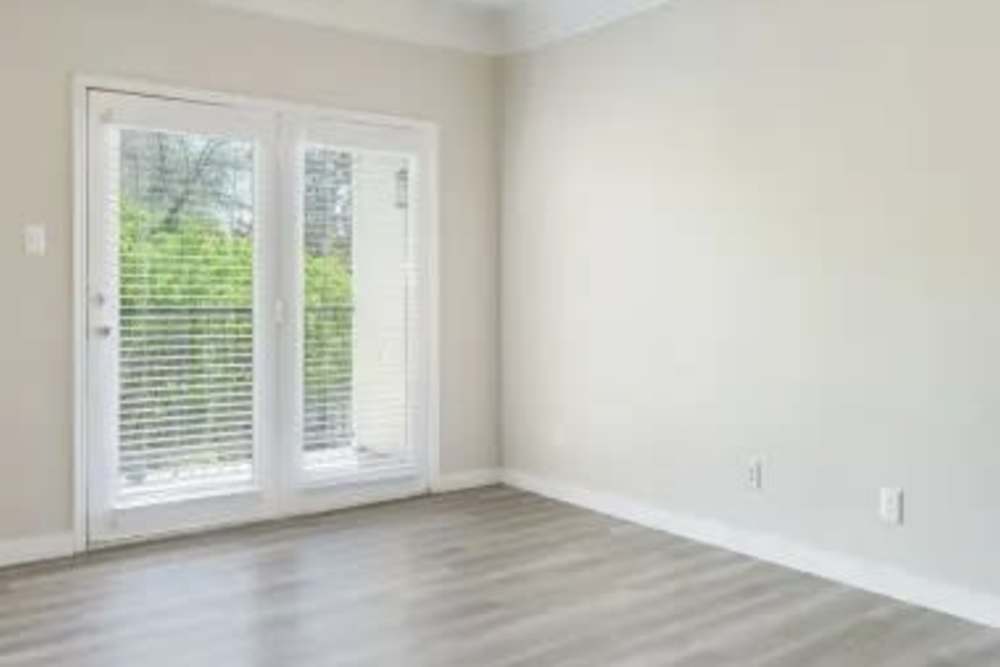 Spacious living room with balcony access at Benton in Dallas, Texas, 