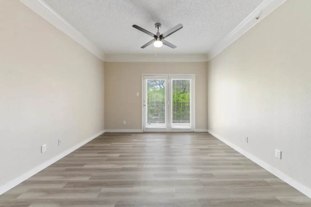 View of spacious living room with wood-style flooring at Benton in Dallas, Texas, 