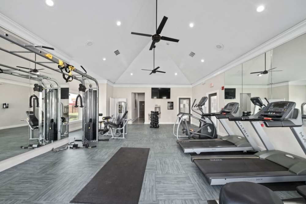 Fully equipped fitness center with ceiling fan and flat-screen TV at Benton in Dallas, Texas, 