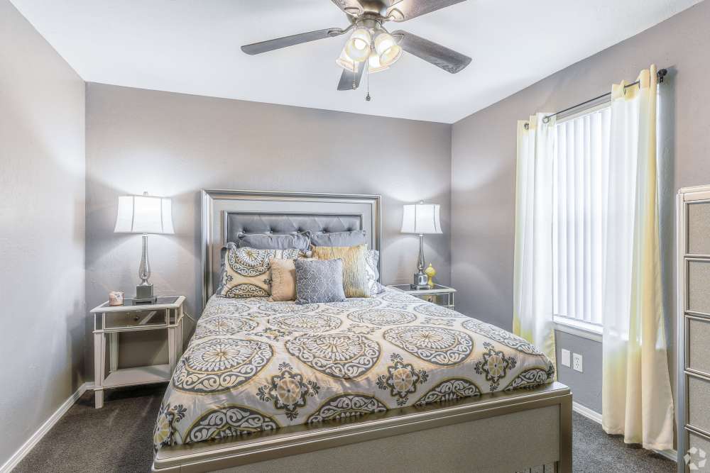 Cozy bedroom in a model home at Oxford Oaks Apartments in Edmond, Oklahoma