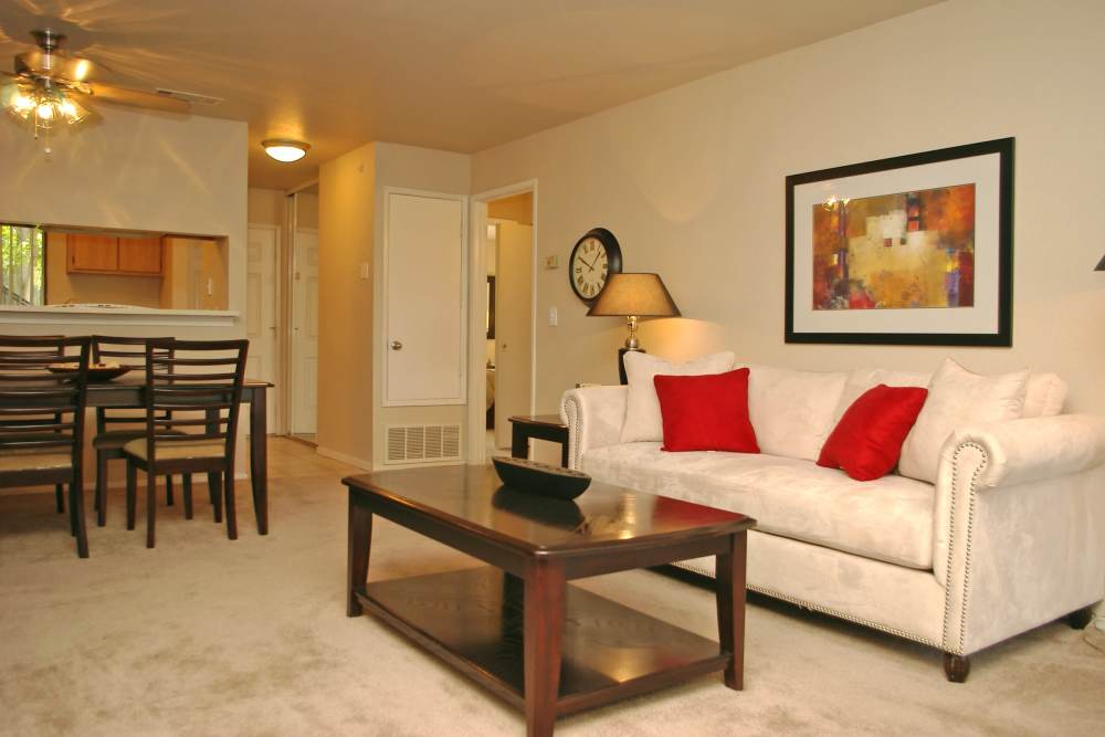 Apartment living room with a white couch at Twin Creeks in Antioch, California