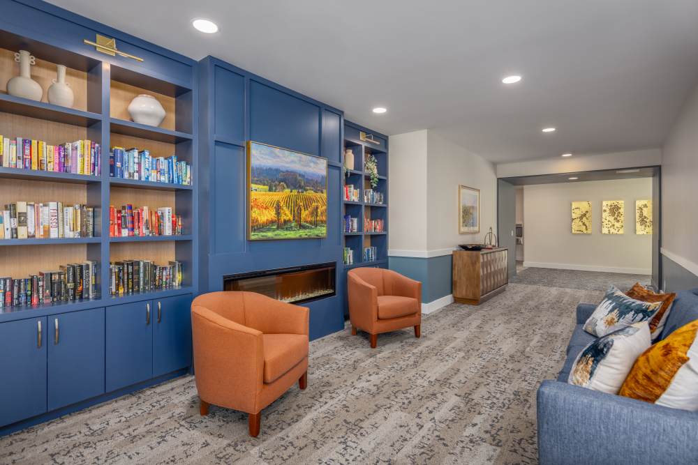 Lounge area with books and a tv at Clearwater Beaverton in Beaverton, Oregon