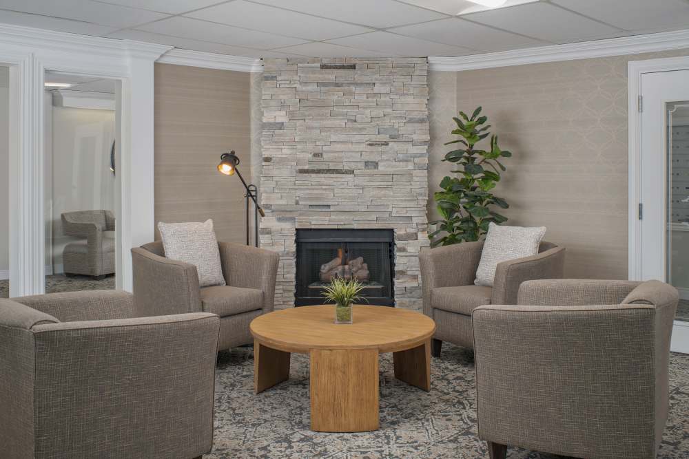 Spacious room with four single couches and a round table at Peaks at Millcreek in Salt Lake City, Utah