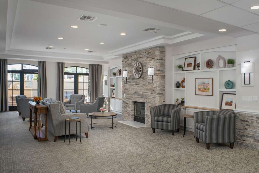 Spacious room with a fireplace and chairs at Ridge at the Stratford in Phoenix, Arizona
