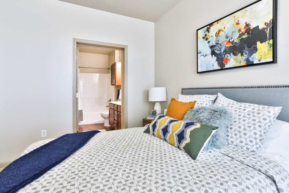 Bedroom with attached bathroom at Residences at The Streets of St. Charles Apartment Homes in Saint Charles, Missouri 