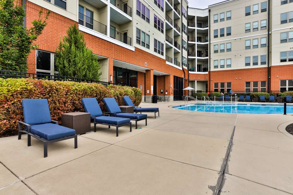 Lounge chair in sundeck near pool at Residences at The Streets of St. Charles Apartment Homes in Saint Charles, Missouri 