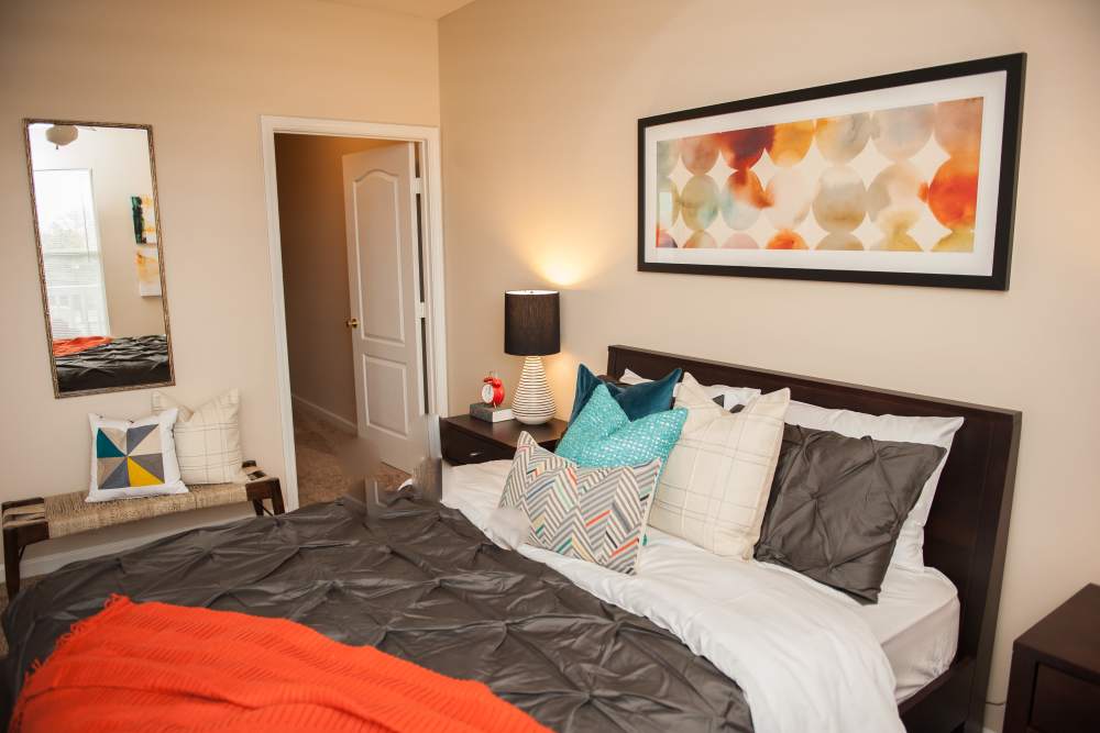 Spacious bedroom with a wall-mounted mirrors at Waterford Place Apartments & Townhomes in Memphis,Tennessee